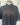 Black shirt on a mannequin against a white wall
