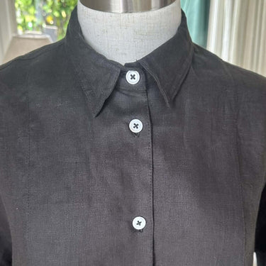 Dark gray shirt on a mannequin with buttons