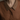 Close-up of a brown shirt with a collar against a neutral background